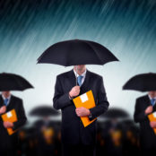 Man-holding-an-umbrella-holding-folder-Stock-Photo